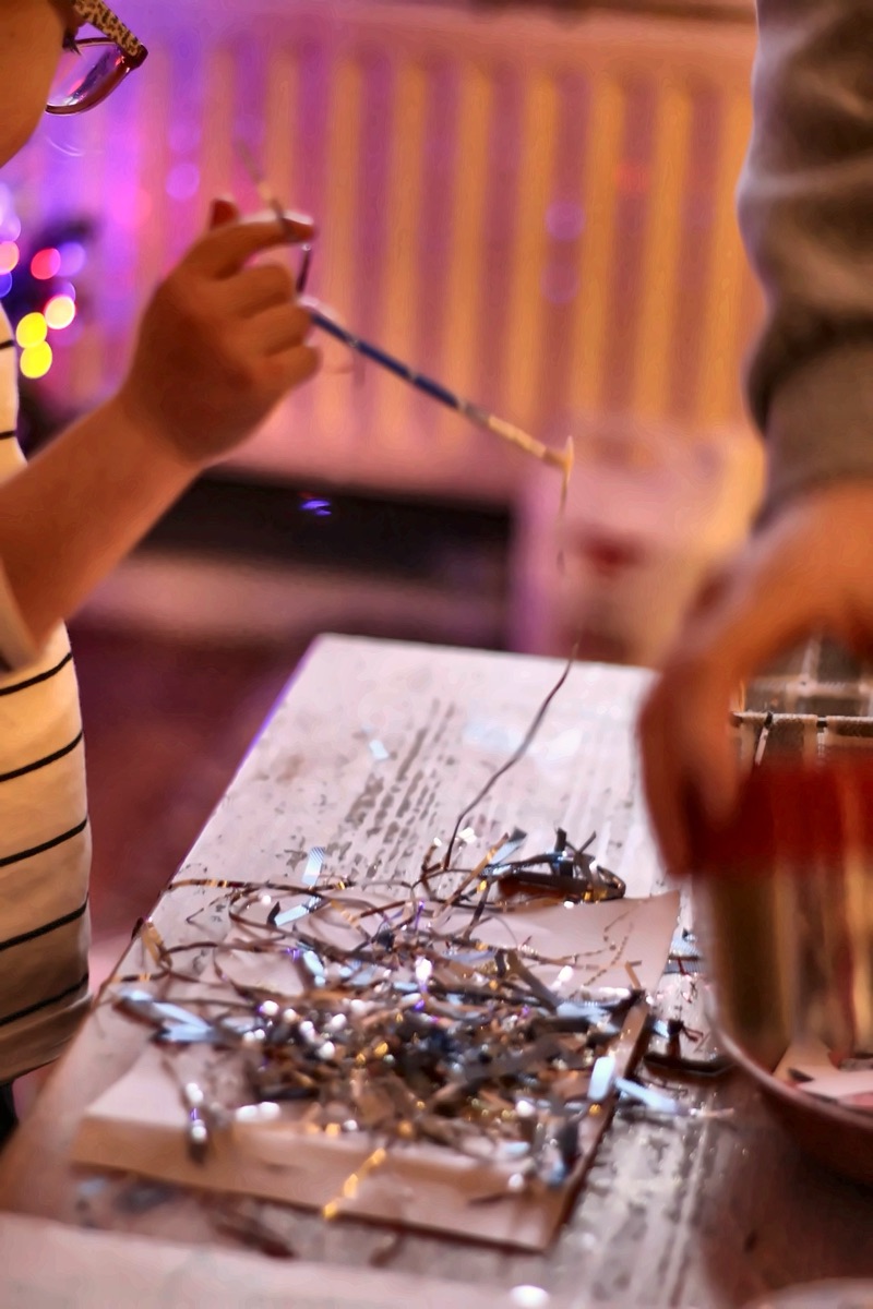 Children doing tinsel art and crafts inside the nursery